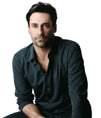 Join_REV A man in a black shirt sitting on a stool.
