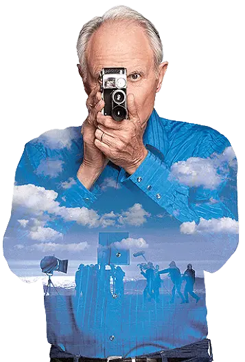 Services_REV A man holding a camera with clouds in the background.