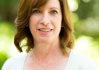 rachel reiff A woman wearing a white shirt and a necklace.
