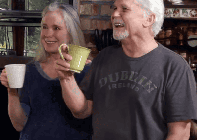 The-Original-Foodie-Tony-and-Lauren-Dow-Outing-&-Nutrition-with-Maureen.mp4_snapshot_09.59 A man and woman standing in a kitchen holding coffee mugs.