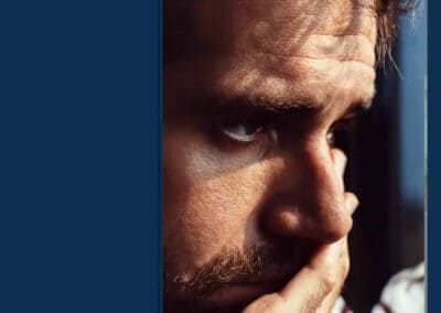 suicide_webinar A man with his hand on his face.