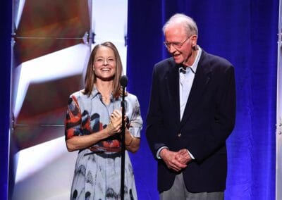 Jodie Foster Harry Northup MPTF100 A man and woman standing next to each other on stage.