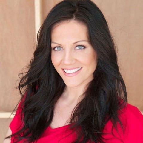Melissa Ritz A woman with long black hair smiling in a red shirt.