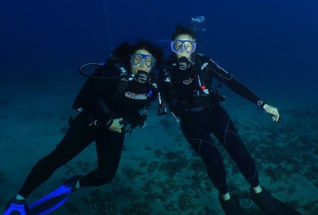 Maria Victoria Two scuba divers posing for a photo.