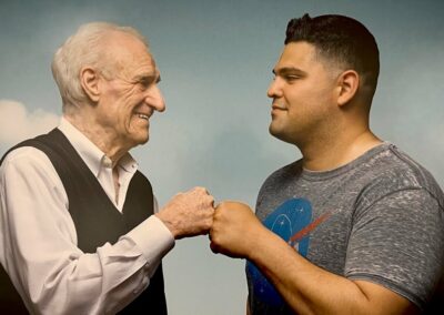 MPTF’s Veterans Benefits Assistance Program (BQ) An older man and a younger man are standing next to each other.
