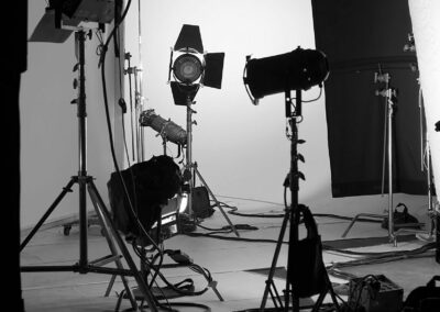 Production Set A black and white photo of a studio with lighting equipment.